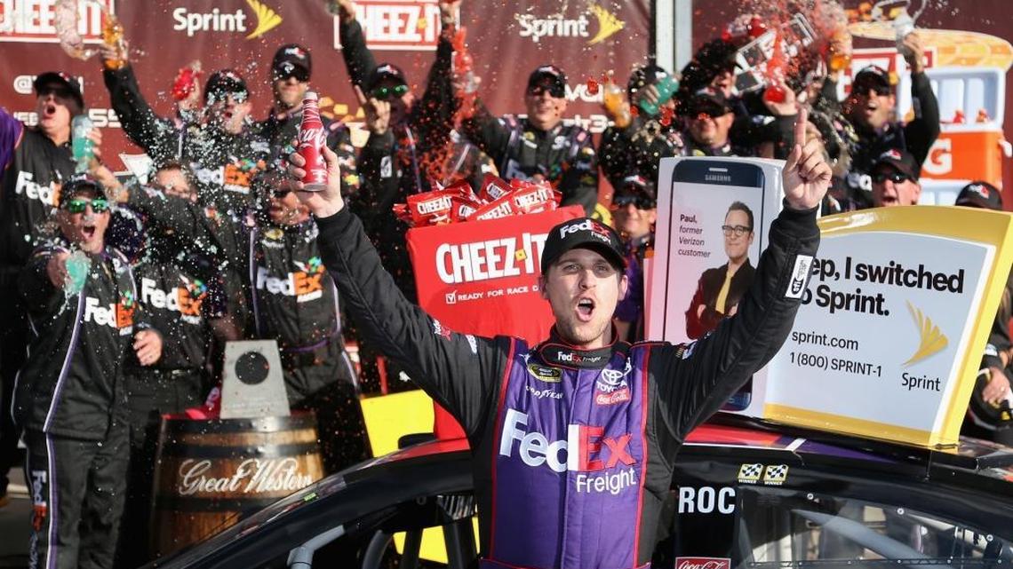 Denny Hamlin, driver of the #11 FedEx Freight Toyota, celebrates in victory lane after winning the NASCAR Sprint Cup Series Cheez-It 355 at Watkins Glen International on August 7, 2016 in Watkins Glen, New York.