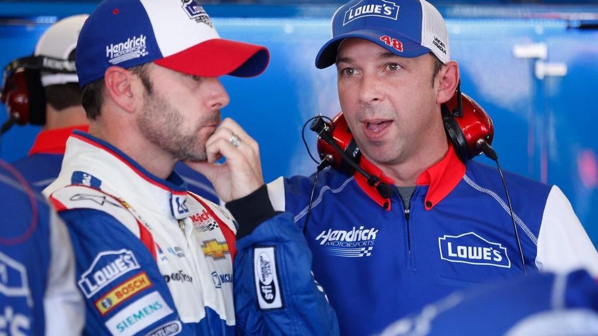Jimmie Johnson and crew chief Chad Knaus speak in the garage area during Friday’s practice for the NASCAR Sprint Cup Series Quicken Loans Race for Heroes 500 at Phoenix International Raceway.