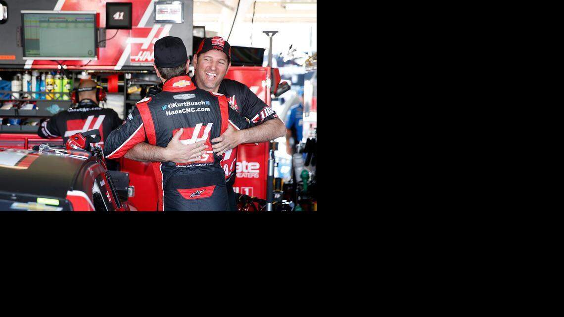 
A crew member on his Stewart-Haas Racing team embraces Kurt Busch on Friday in the garage at Phoenix International Raceway in Busch’s first day back since serving a suspension.
