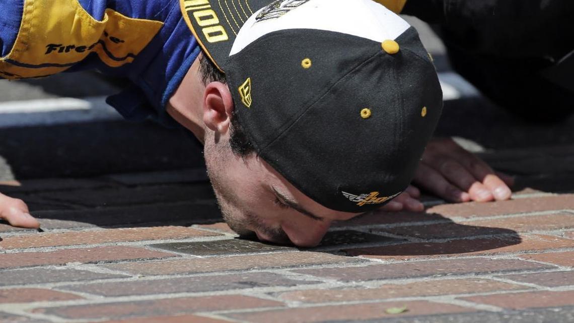 Alexander Rossi kisses the bricks on the start/finish line after wining the 100th running of the Indianapolis 500 auto race at Indianapolis Motor Speedway in Indianapolis.