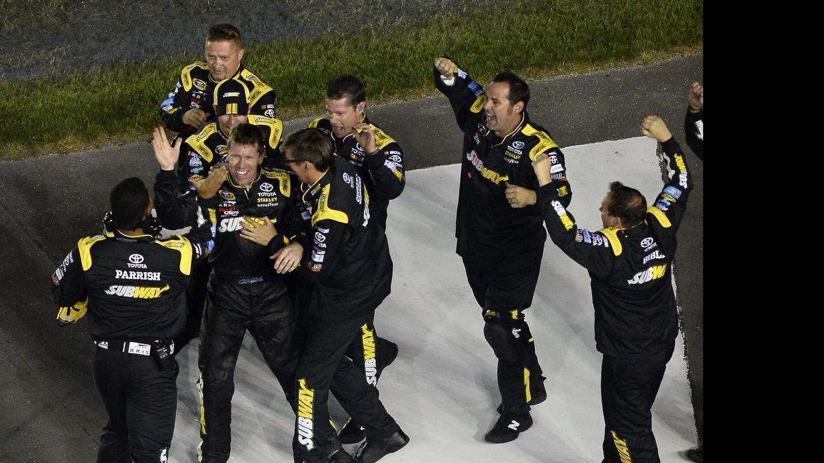 
NASCAR Sprint Cup Series driver Carl Edwards is congratulated by his team as they celebrate their victory in the Coca-Cola 600 at the start/finish line at Charlotte Motor Speedway on Sunday, May 24, 2015. 
