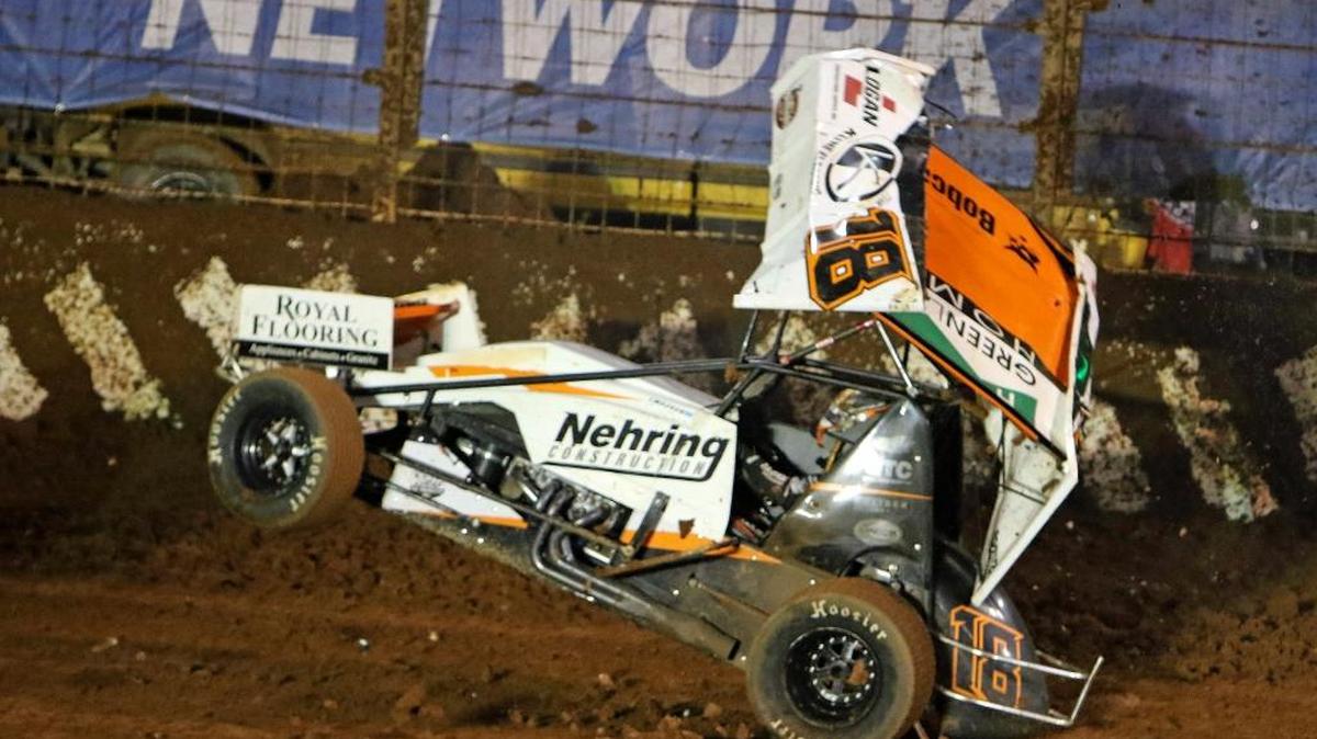 Paul McMahan's sprint car lands on its wheels after flipping into the catch fence in the first and second turns during one of the heat races at the BAD BOYS BUGGIES World of Outlaws WORLD FINALS on Friday at The Dirt Track at Charlotte in Concord, NC (HHP/Tim Parks)