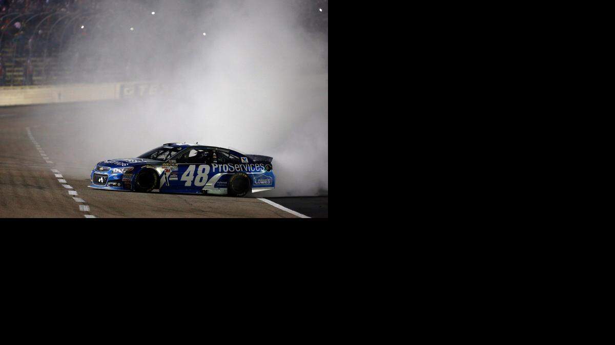 
Jimmie Johnson celebrates with a burnout after winning the Duck Commander 500 at Texas Motor Speedway on Saturday night in Fort Worth, Texas. 
