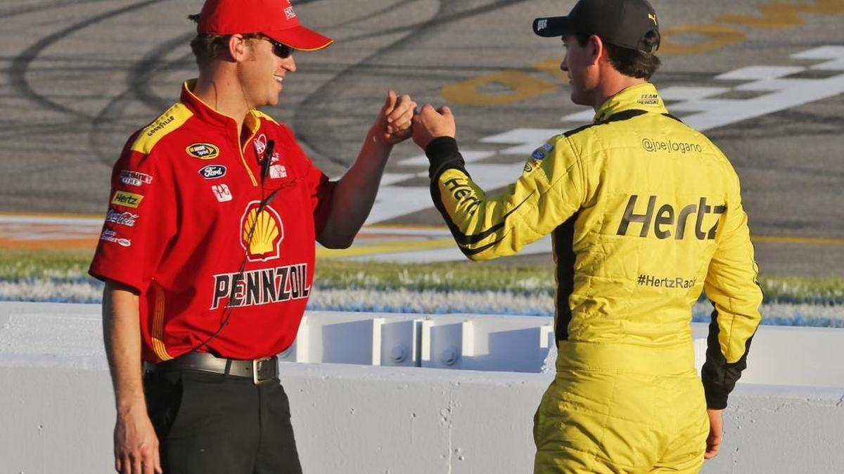 
Joey Logano, right, fist-bumps a crew member after qualifying on the pole for Saturday's NASCAR Sprint Cup auto race at Richmond International Raceway in Richmond, Va., on Friday.
