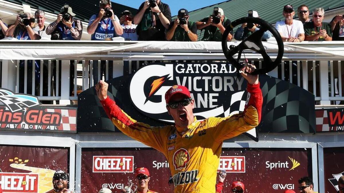 
Joey Logano celebrates in victory lane after winning the NASCAR Sprint Cup Series Cheez-It 355 at the Glen at Watkins Glen International on Sunday, Aug. 9, 2015 in Watkins Glen, N.Y.
