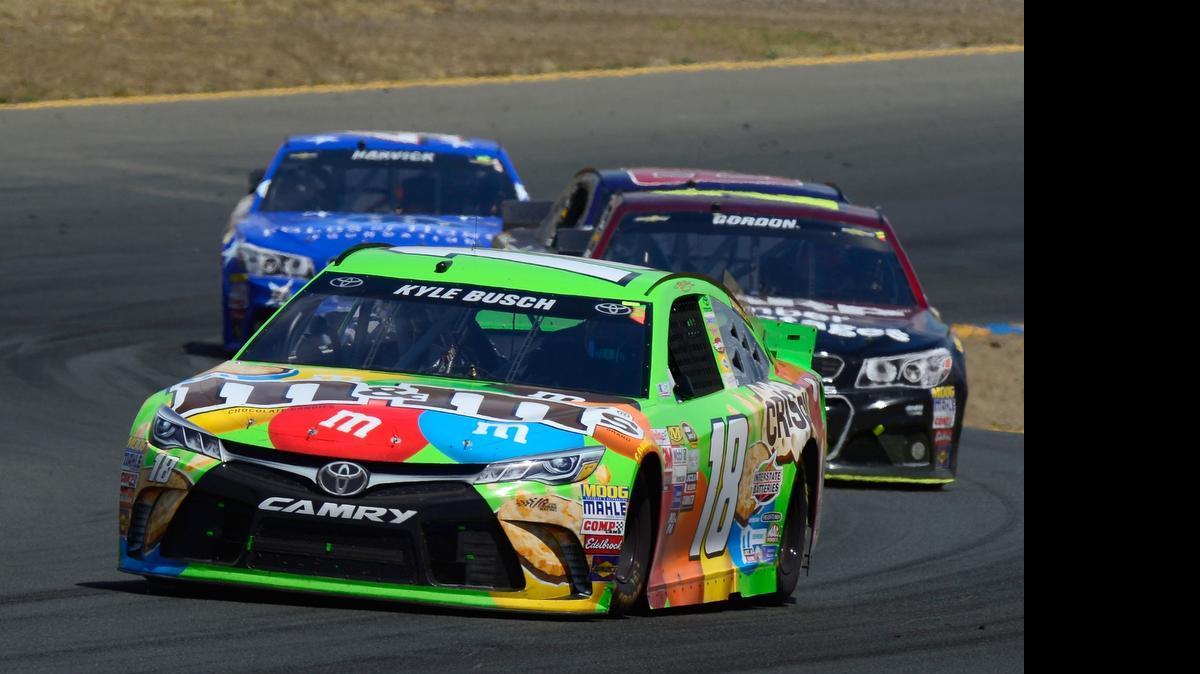 
Kyle Busch, driver of the #18 M&M's Crispy Toyota, leads a pack of cars during the NASCAR Sprint Cup Series Toyota/Save Mart 350 at Sonoma Raceway on June 28, 2015 in Sonoma, California. 
