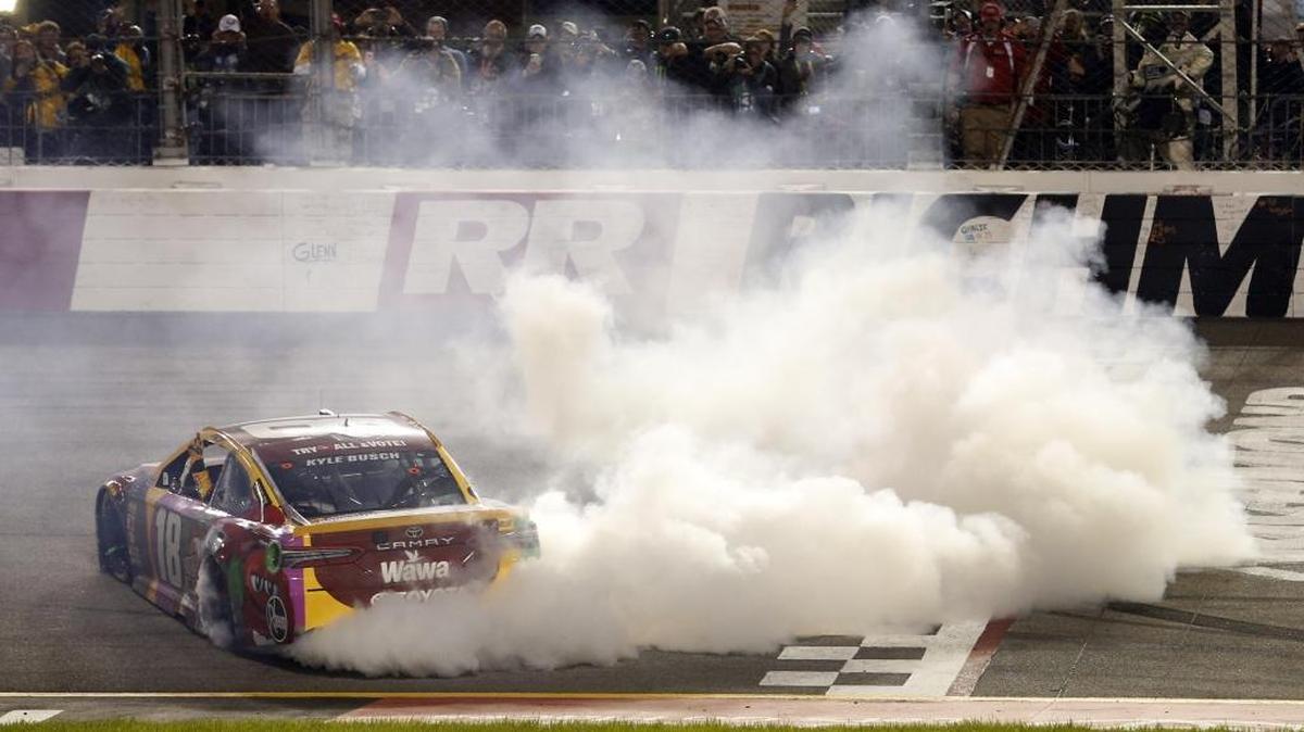 Kyle Busch outran Chase Elliott and teammate Denny Hamlin for his fifth career victory at April’s Cup series race Richmond Raceway, Above, Busch celebrates with a burnout. Alon Day, a driver from Tel Aviv, Israel, will add an international flare to Saturday’s Cup race at Richmond when he makes his 2018 Cup series debut.