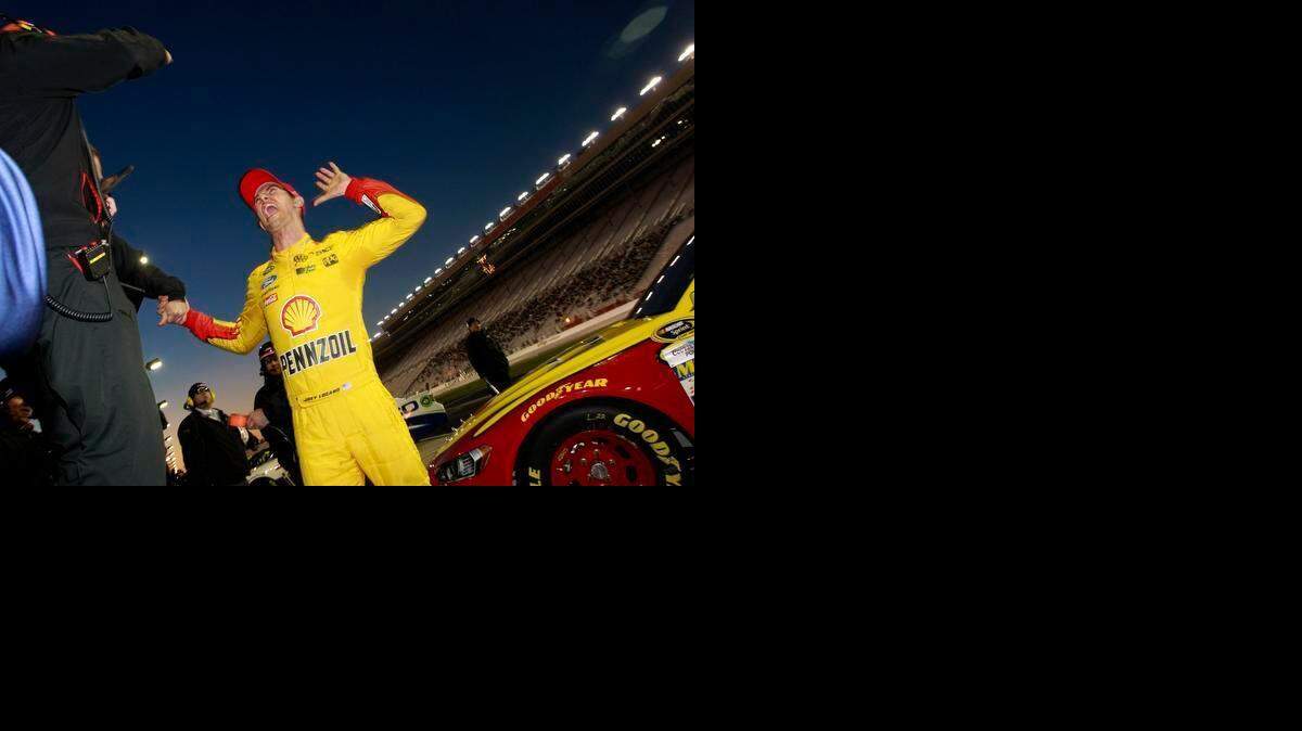
Joey Logano celebrates with crew members after qualifying for the pole position for the NASCAR Sprint Cup Series Folds of Honor QuikTrip 500 at Atlanta Motor Speedway on Friday, Feb. 27, 2015 in Hampton, Ga. 
