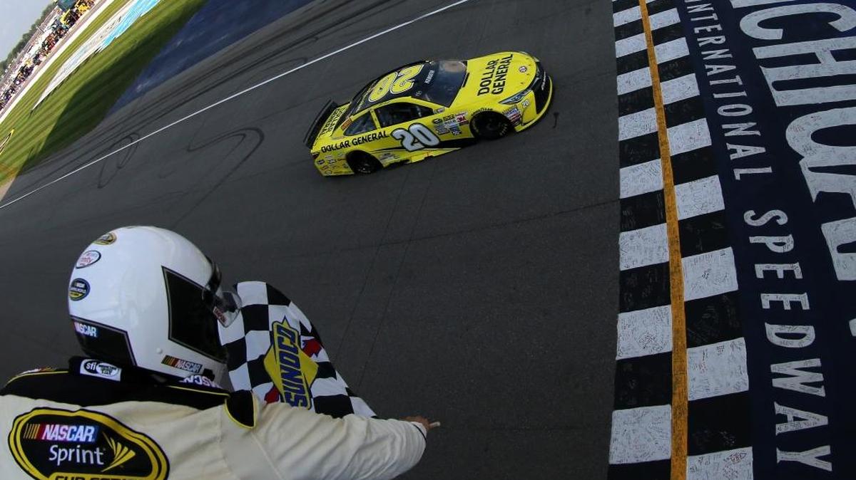 In this photo taken with a fisheye lens provided by NASCAR, Matt Kenseth takes the checkered flag to win the NASCAR Sprint Cup Series Pure Michigan 400 at Michigan International Speedway on Aug. 16, 2015, in Brooklyn, Mich.