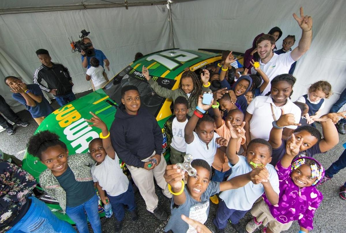 Joe Gibbs Racing driver Daniel Suarez poses with his car bearing the Subway brand and some children from the Salvation Army Boys & Girls Club of Greater Charlotte in a May 23 event to promote the sandwich chain and the Disney/Pixar film “Cars 3.” Subway pulled out of a four-race sponsorship with Suarez with one race left.