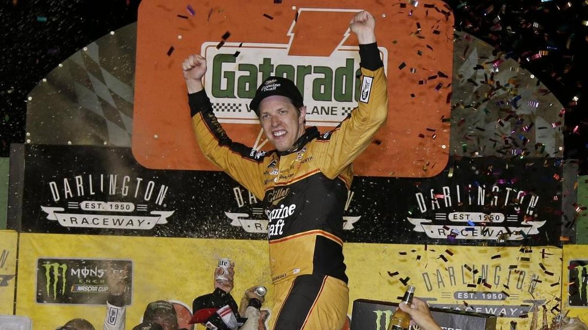 Brad Keselowski celebrates in his first win of the NASCAR Cup series season at Darlington Raceway in Darlington, S.C., on Sunday. Keselowski beat Kyle Larson off pit road and pulled away for the victory.