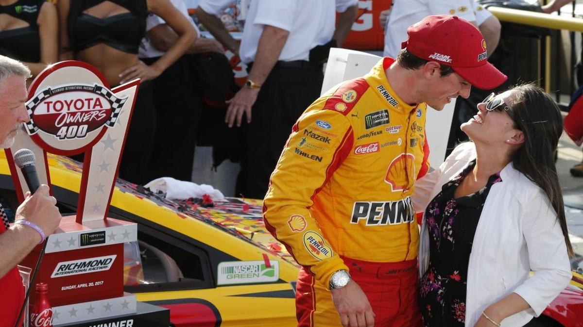 Joey Logano celebrates with his wife Brittany Baca, right, in Victory Lane after winning Sunday’s NASCAR Cup Series auto race at Richmond International Raceway in Richmond, Va.