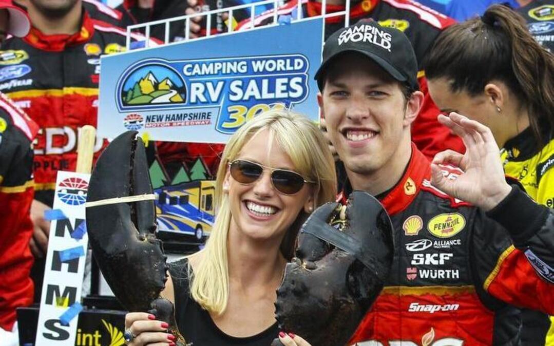 NASCAR driver Brad Keselowski and his wife, Paige, seen here celebrating a Cup win in 2014, met in 2013 and have one daughter.