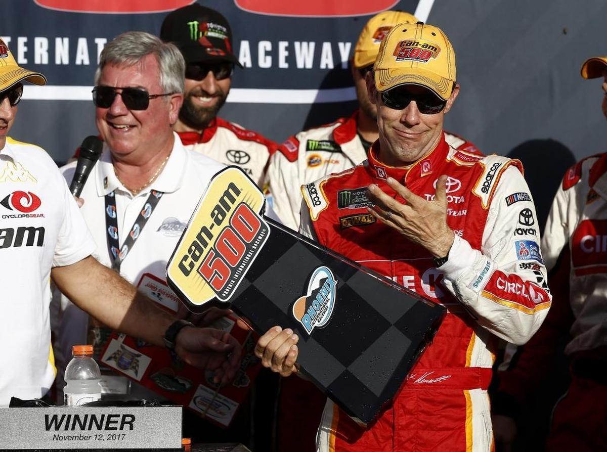 Matt Kenseth reacts after his winner's trophy broke as he picked it up in Victory Lane after Sunday’s win at Phoenix International Raceway in Avondale, Ariz.