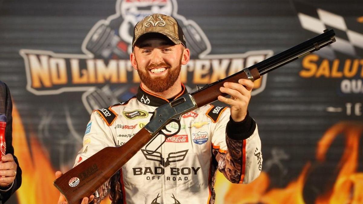 Austin Dillon shows off the rifle he won by taking the pole Friday for Sunday’s Texas AAA 500 at Texas Motor Speedway.