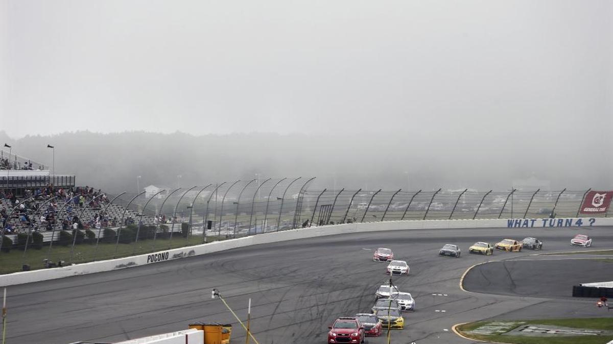 The pace car leads drivers off the track as fog moves in over Pocono Raceway during Monday’s NASCAR Sprint Cup Series’ Pennsylvania 400 in Long Pond, Pa.