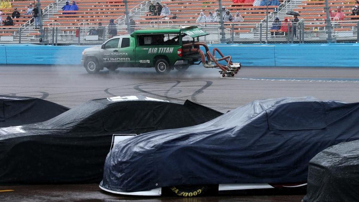 An Air Titan dries the racing surface during a rain delay for Sunday’s NASCAR Sprint Cup Series Quicken Loans Race for Heroes 500 at Phoenix International Raceway.