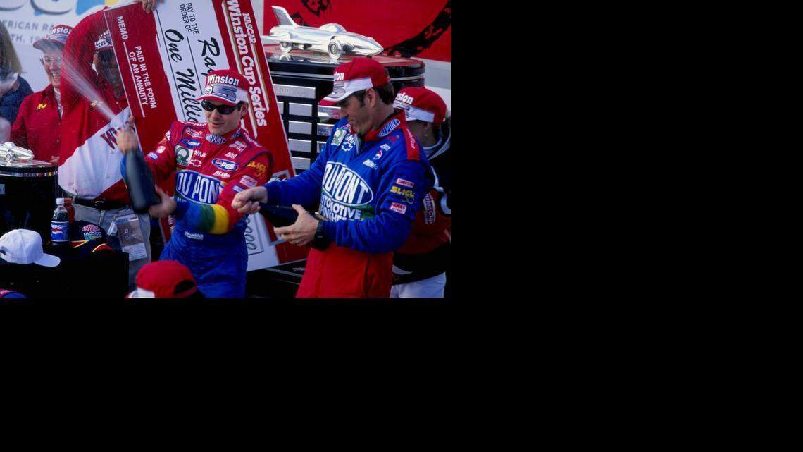
 Jeff Gordon, left,  and crew chief Ray Evernham spray champagne on the crowd after winning the 1999 Daytona 500 at the Daytona International Speedway. 
