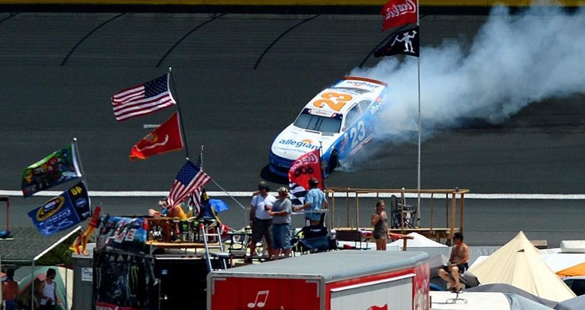 NASCAR Xfinity Series driver Spencer Gallagher slides sideways out of Turn 1 as fans mingle Saturday’s Hisense 4K TV 300 at Charlotte Motor Speedway.