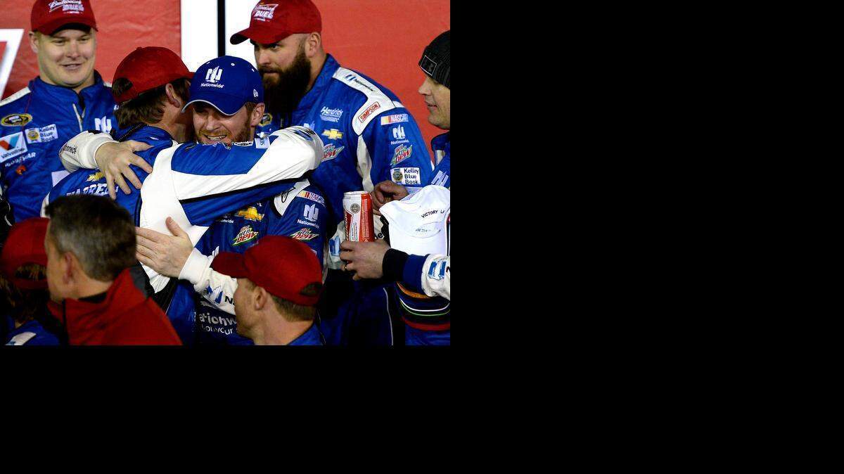 
 NASCAR Sprint Cup Series driver Dale Earnhardt Jr., center, hugs his crew members as they celebrate their victory in the first of two Duel 150 mile qualifying races for the Daytona 500 at Daytona International Speedway on Thursday, Feb. 19, 2015.
