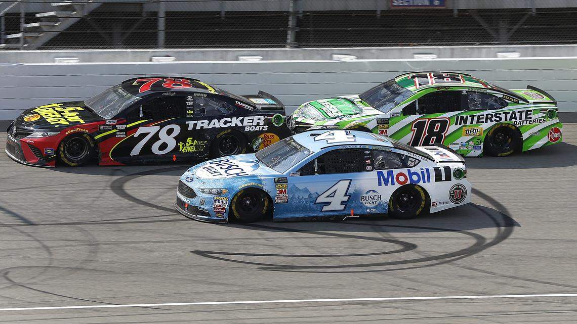 Martin Truex Jr. (78), Kevin Harvick (4) and Kyle Busch (18) race each other for position during a NASCAR Cup Series auto race at Michigan International Speedway in Brooklyn, Mich., Sunday, Aug. 12, 2018. (AP Photo/Paul Sancya)