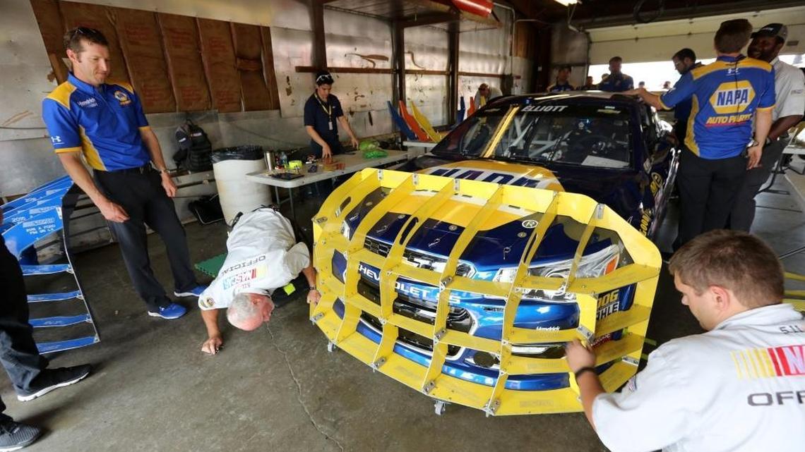 NASCAR officials inspect Chase Elliott’s car before qualifying Friday for Sunday’s Firekeepers Casino 400 at Michigan International Speedway.