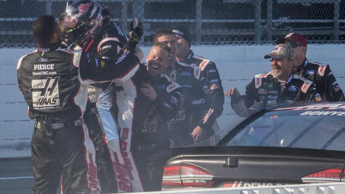 Clint Bowyer (wearing helmet) celebrates with his crew after winning a NASCAR Cup series auto race at Martinsville Speedway in Martinsville, Va., on Monday.