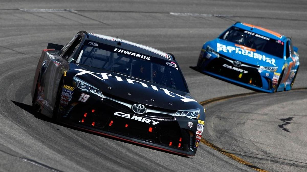 Carl Edwards, driver of the #19 XFINITY Toyota, races Kyle Busch, driver of the #18 Banfield Toyota, during the NASCAR Sprint Cup Series TOYOTA OWNERS 400 at Richmond International Raceway on April 24, 2016 in Richmond, Virginia.