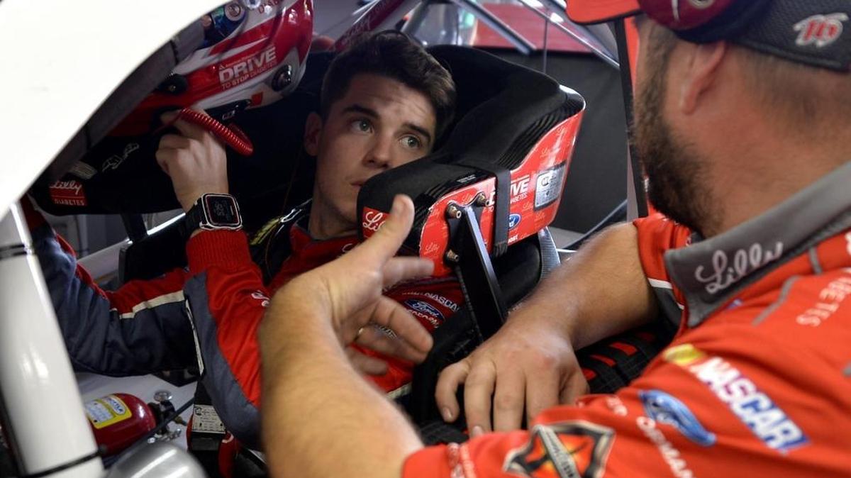 NASCAR Xfinity Series driver Ryan Reed, left, talks with a crew member before practice at Charlotte Motor Speedway on Thursday. Reed, who lives with Type 1 diabetes, is 10th in the Xfinity series standings.