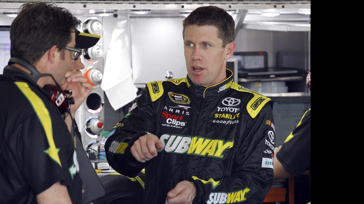 
Carl Edwards, right, talks to crew members before practice for Sunday's NASCAR Coca-Cola 600 Sprint Cup series auto race at Charlotte Motor Speedway in Concord, Thursday, May 21, 2015. 
