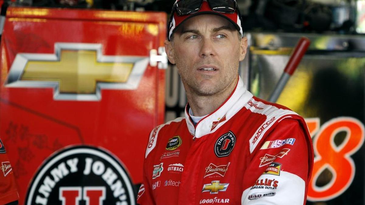 Kevin Harvick looks on from the garage area before Saturdya’s practice for Sunday's NASCAR Sprint Cup Series auto race at Phoenix International Raceway. Harvick is looking to win his fifth straight race at Phoenix and clinch a spot in the final Chase for the Cup championship race in Homestead, Fla.