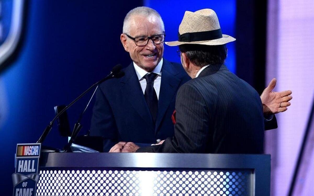 Former NASCAR driver Mark Martin, left, is inducted into the Hall of Fame by NASCAR team owner Jack Roush on Friday .