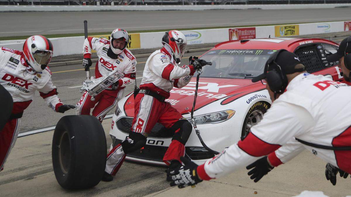 Ryan Blaney makes a pit stop during the NASCAR Cup Series auto race, Sunday, June 10, 2018, in Brooklyn, Mich. (AP Photo/Carlos Osorio)