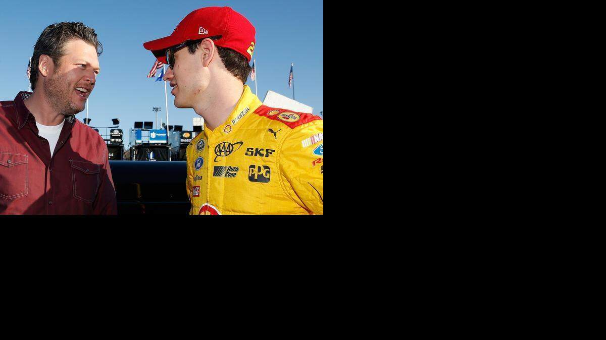 
Country music artist Blake Shelton, left, speaks with Joey Logano during practice for the NASCAR Sprint Cup Series CampingWorld.com 500 at Phoenix International Raceway on Saturday, March 14, 2015 in Avondale, Ariz.
