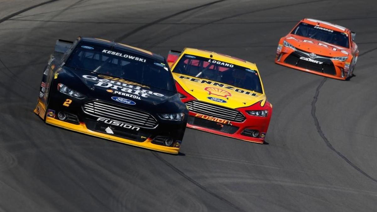 
Brad Keselowski, driver of the #2 Miller Lite Ford, races Joey Logano, driver of the #22 Shell Pennzoil Ford, during the NASCAR Sprint Cup Series Pure Michigan 400 at Michigan International Speedway on August 16, 2015 in Brooklyn, Michigan. 

