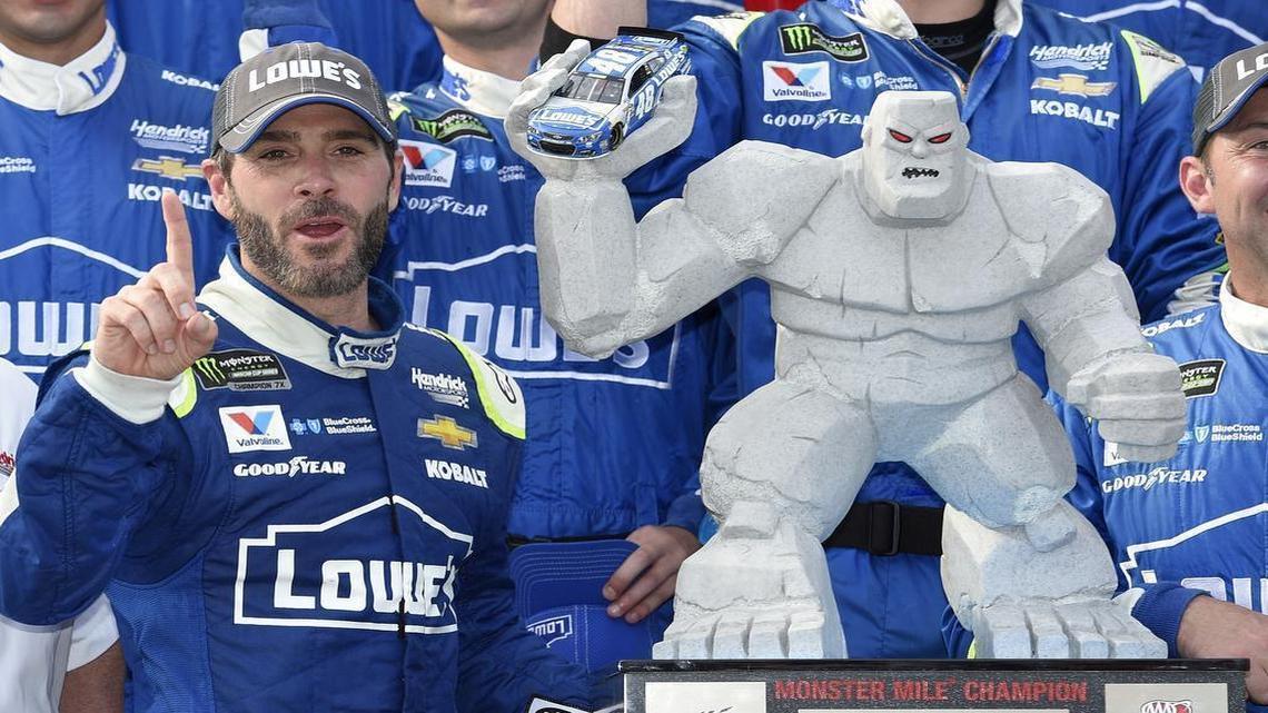 Jimmie Johnson, left, poses with the trophy after he won the AAA 400 Drive for Austism, this week’s NASCAR Cup Series auto race, on Sunday, June 4, 2017, at Dover International Speedway in Dover, Del.