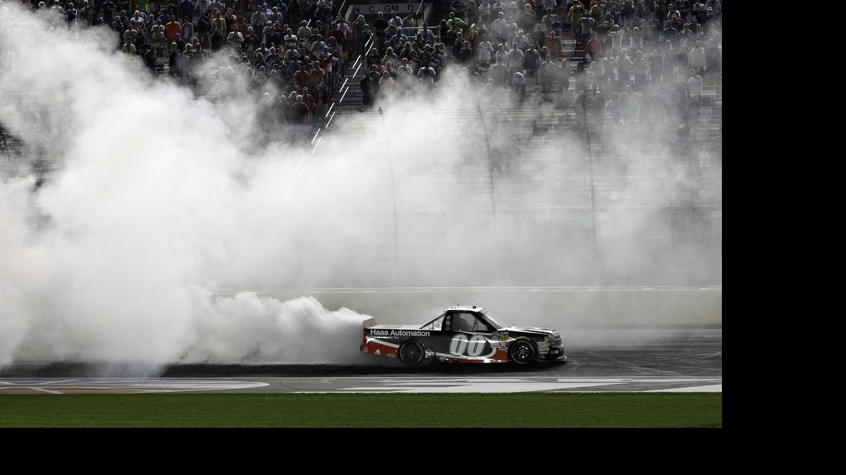 
Kasey Kahne (00) does a burnout after winning the NASCAR Trucks series North Carolina Education Lottery auto race at Charlotte Motor Speedway in Concord, Friday, May 15, 2015. 
