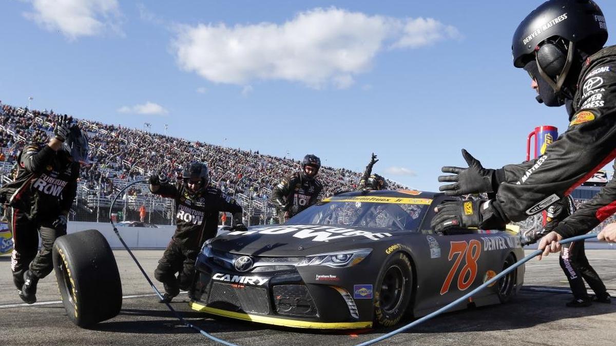 Martin Truex Jr. pits for tires and gas during Sunday’s NASCAR Sprint Cup Series race at New Hampshire Motor Speedway.