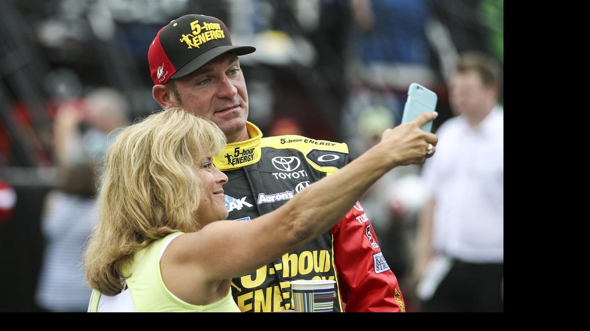 
Driver Clint Bowyer has a selfie taken with a fan as he heads to his garage at the start of practice for Sunday's NASCAR Sprint Cup series auto race at New Hampshire Motor Speedway, Loudon, N.H., Saturday, July 18, 2015. 
