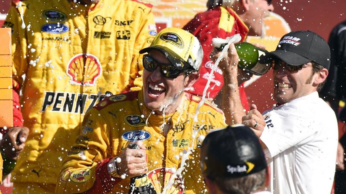 Joey Logano celebrates in the victory lane after winning the NASCAR Sprint Cup series auto race at Watkins Glen International in August 2015.