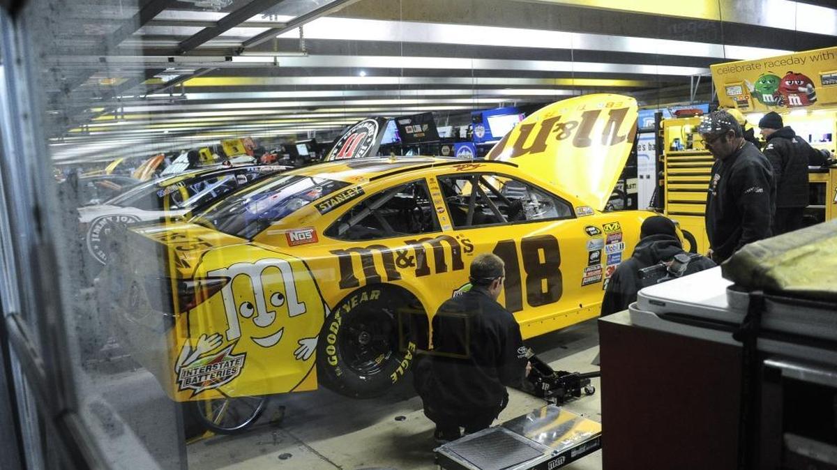 After scoring the fastest speed in Friday’s QuikTrip 500 qualifying, the car driven by Sprint Cup Series driver Kyle Busch is worked on by crew members in the garage after if failed post-qualifying inspection. The pole position was awarded to his brother Kurt Busch.