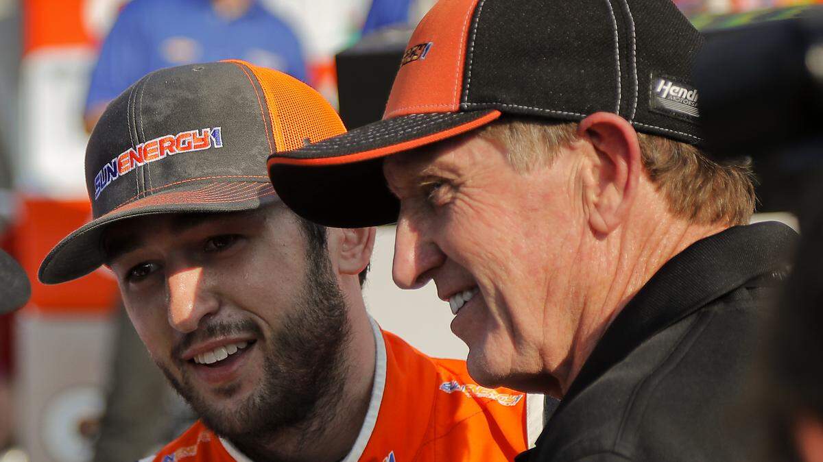 Chase Elliott, left, and his father Bill Elliott answer questions during an interview after Chase won a NASCAR Cup Series auto race, Sunday, Aug. 5, 2018, in Watkins Glen, N.Y. (AP Photo/Julie Jacobson)