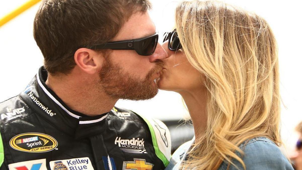 
Dale Earnhardt Jr., driver of the #88 AMP ENERGY Chevrolet, kisses Amy Reimann prior to the NASCAR Sprint Cup Series Quicken Loans 400 at Michigan International Speedway on June 14, 2015 in Brooklyn, Michigan.
