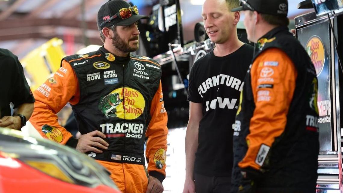 Driver Martin Truex Jr. (left) and crew chief Cole Pearn (center) talk in the garage after the engine blew in their No. 78 Toyota at Talladega Superspeedway on Sunday.