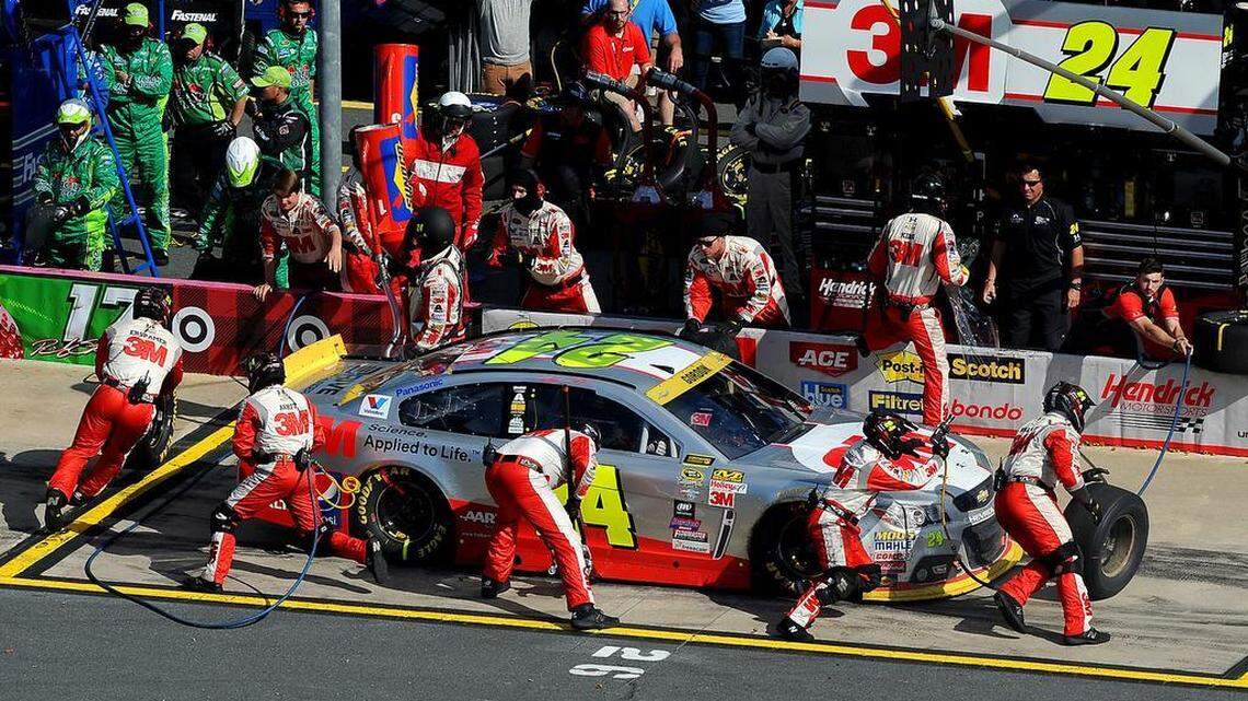 
NASCAR Sprint Cup Series driver Jeff Gordon's pit crew hurry to change the tires and refuel during his final pit stop during the Bank of America 500 at Charlotte Motor Speedway in Concord, NC on Sunday, October 11, 2015. Gordon finished the race in eighth place.
