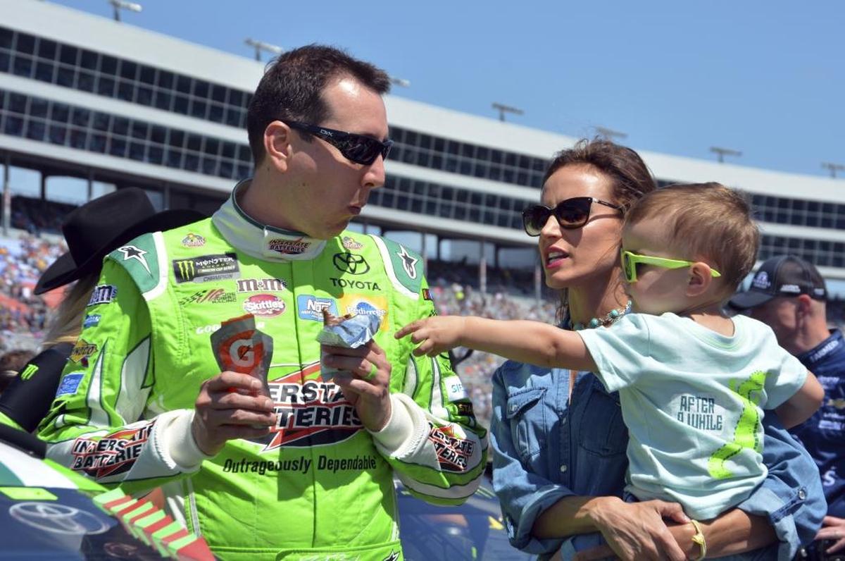 Kyle Busch jokes with his son Brexton, right, as he talks with his wife, Samantha, center, on pit road before the NASCAR Cup Series auto race at Texas Motor Speedway in Fort Worth, Texas.