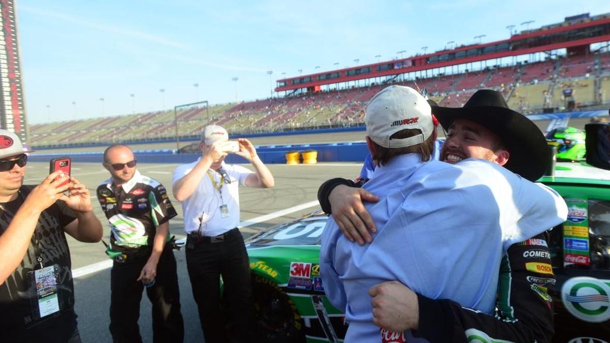 Austin Dillon, right, gets a hug from his grandfather Richard Childress after taking the pole position Friday for the NASCAR auto race at Auto Club Speedway in Fontana, Calif.
