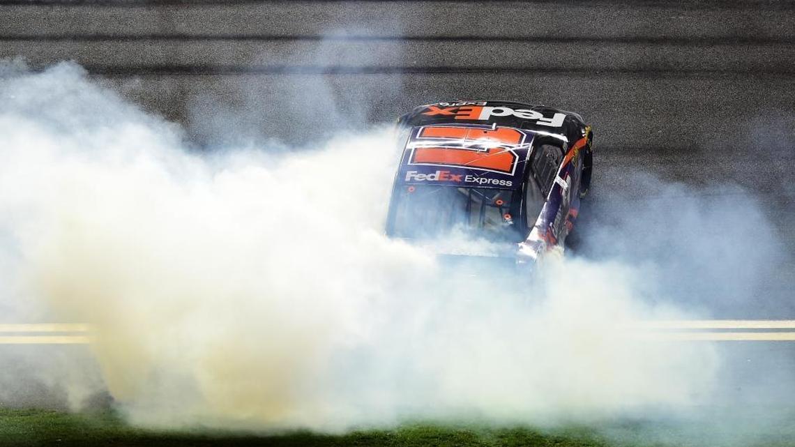 Denny Hamlin celebrates winning Saturday’s NASCAR Sprint Cup Series Sprint Unlimited at Daytona International Speedway with a burnout.
