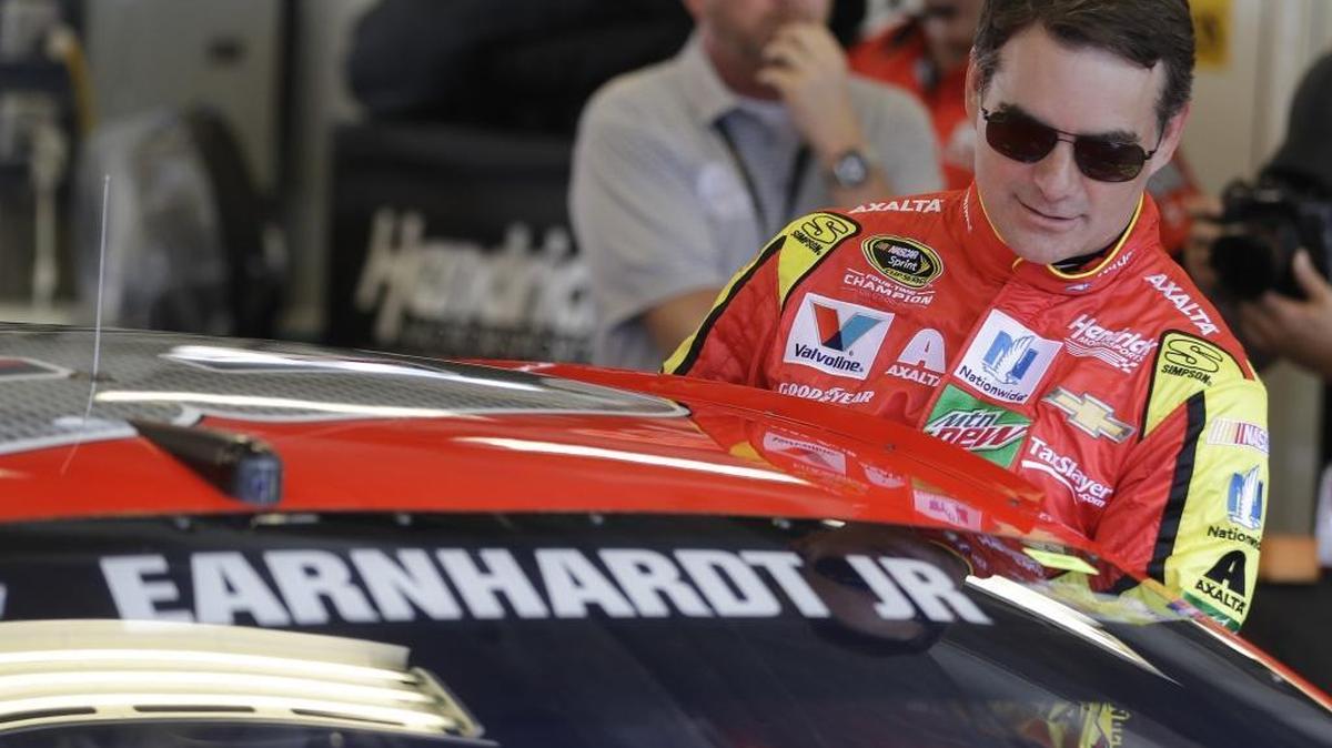 Jeff Gordon climbs into Dale Earnhardt Jr.’s car Friday before practice at Indianapolis Motor Speedway.