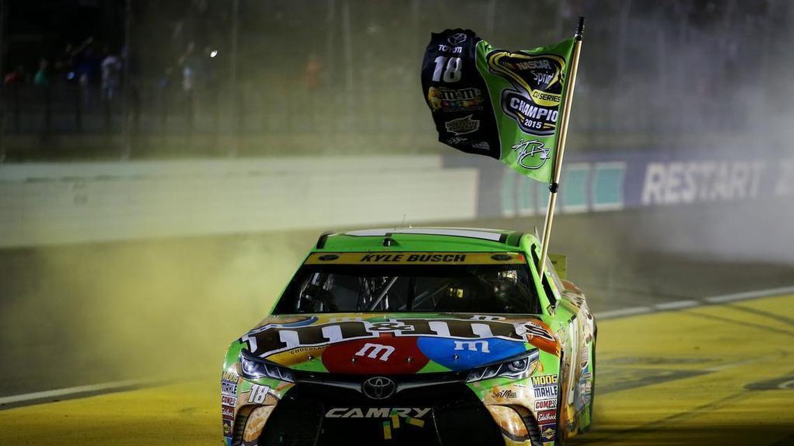 Kyle Busch celebrates winning the NASCAR Sprint Cup series championship and Sunday’s Ford EcoBoost 400 at Homestead-Miami Speedway with a burnout after the race.